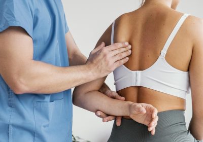 side-view-male-osteopathic-therapist-checking-female-patient-s-scapula-bone-scaled.jpg